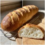 A freshly baked loaf of French bread resting on a cooling rack next to a cross-section showing the airy interior.