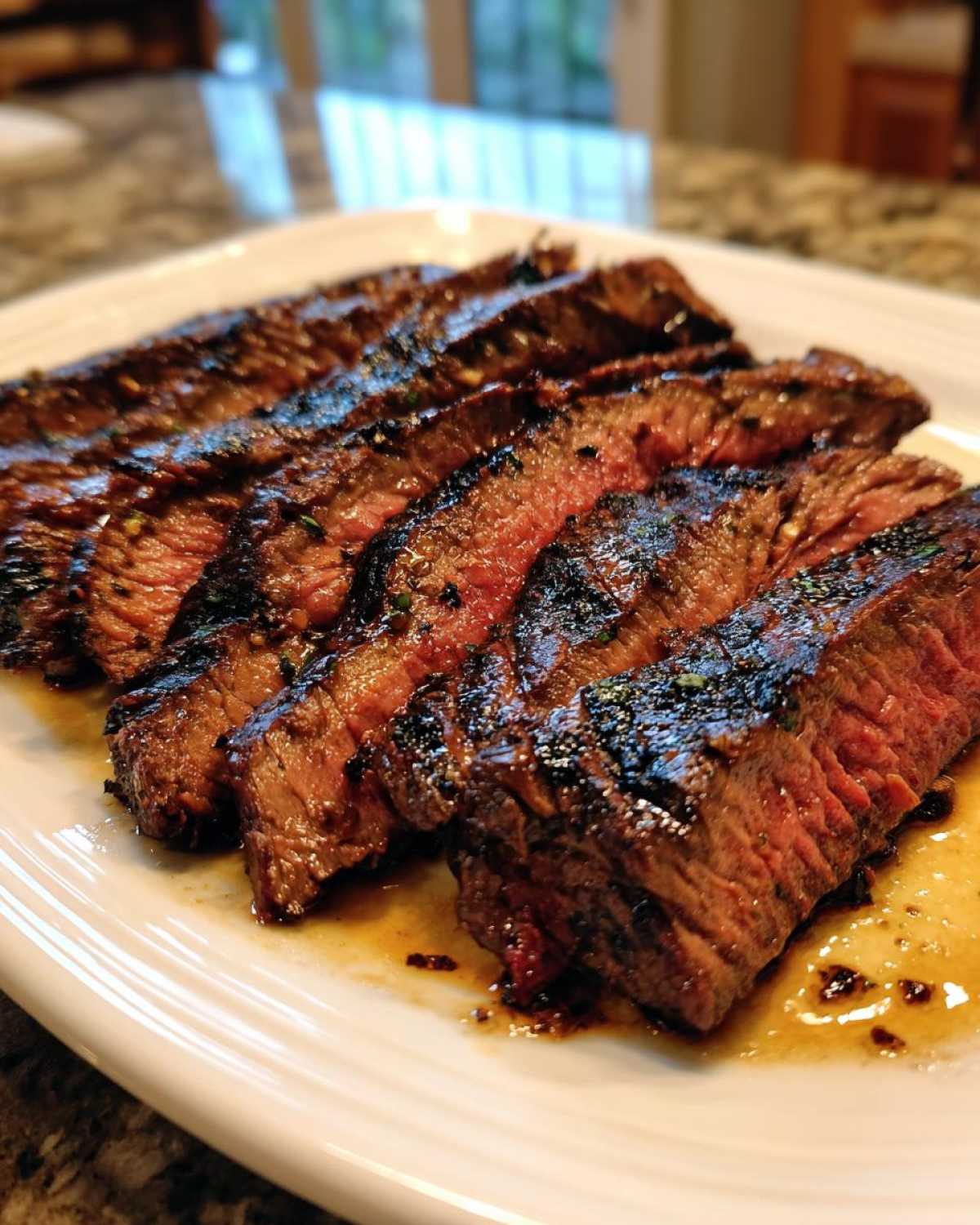 Close-up of perfectly grilled and sliced steak, showing a medium-rare interior, prepared with carne asada marinade.