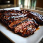 Close-up of medium-rare sliced steak, showing char marks from grilling, made with Carne asada marinade.