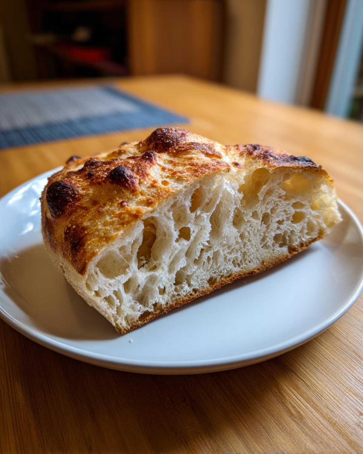 Close-up of the airy, open crumb structure of bread made from sourdough discard pizza dough.