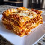 A tall, cheesy slice of Lasagna with Cottage Cheese layered with meat sauce and melted mozzarella.