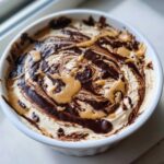 Close-up of Chocolate Peanut Butter Cheesecake Dip with chocolate and peanut butter swirled on top.