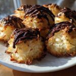 A plate of freshly baked Coconut Macaroons with Dark Chocolate Drizzle, featuring toasted edges and rich chocolate topping.