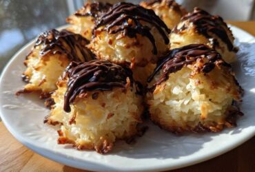 A plate of freshly baked Coconut Macaroons with Dark Chocolate Drizzle, featuring toasted edges and rich chocolate topping.