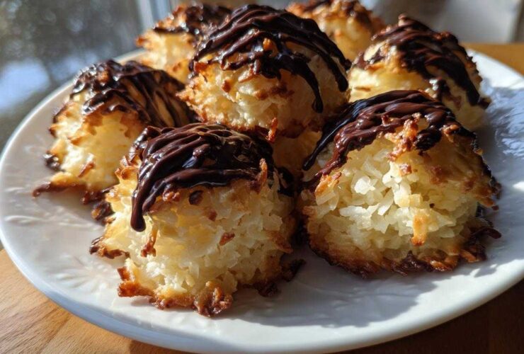 A plate of freshly baked Coconut Macaroons with Dark Chocolate Drizzle, featuring toasted edges and rich chocolate topping.