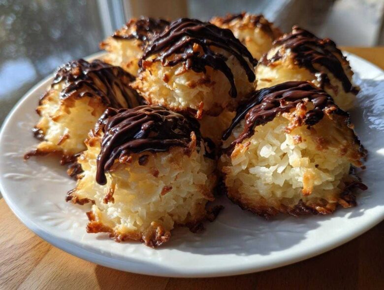 A plate of freshly baked Coconut Macaroons with Dark Chocolate Drizzle, featuring toasted edges and rich chocolate topping.