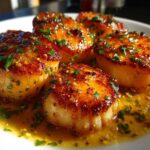 Close-up of perfectly seared Garlic Butter Scallops with Lemon sauce and fresh parsley garnish.