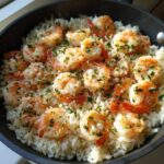 Close-up of Garlic Butter Shrimp and Rice Skillet topped with fresh parsley.