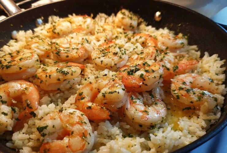 Close-up of Garlic Butter Shrimp and Rice Skillet, featuring plump shrimp seasoned with herbs in a black pan.