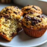 A close-up showing the moist interior and chocolate chunks of Gluten-Free Banana Chocolate Chip Muffins.