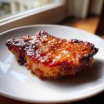 A thick, perfectly cooked Honey Glazed Ham Steak in the Skillet, glistening with a sweet, caramelized glaze.