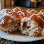 Close-up of soft Hot Cross Buns with Orange Glaze, showing the fluffy interior and raisins.