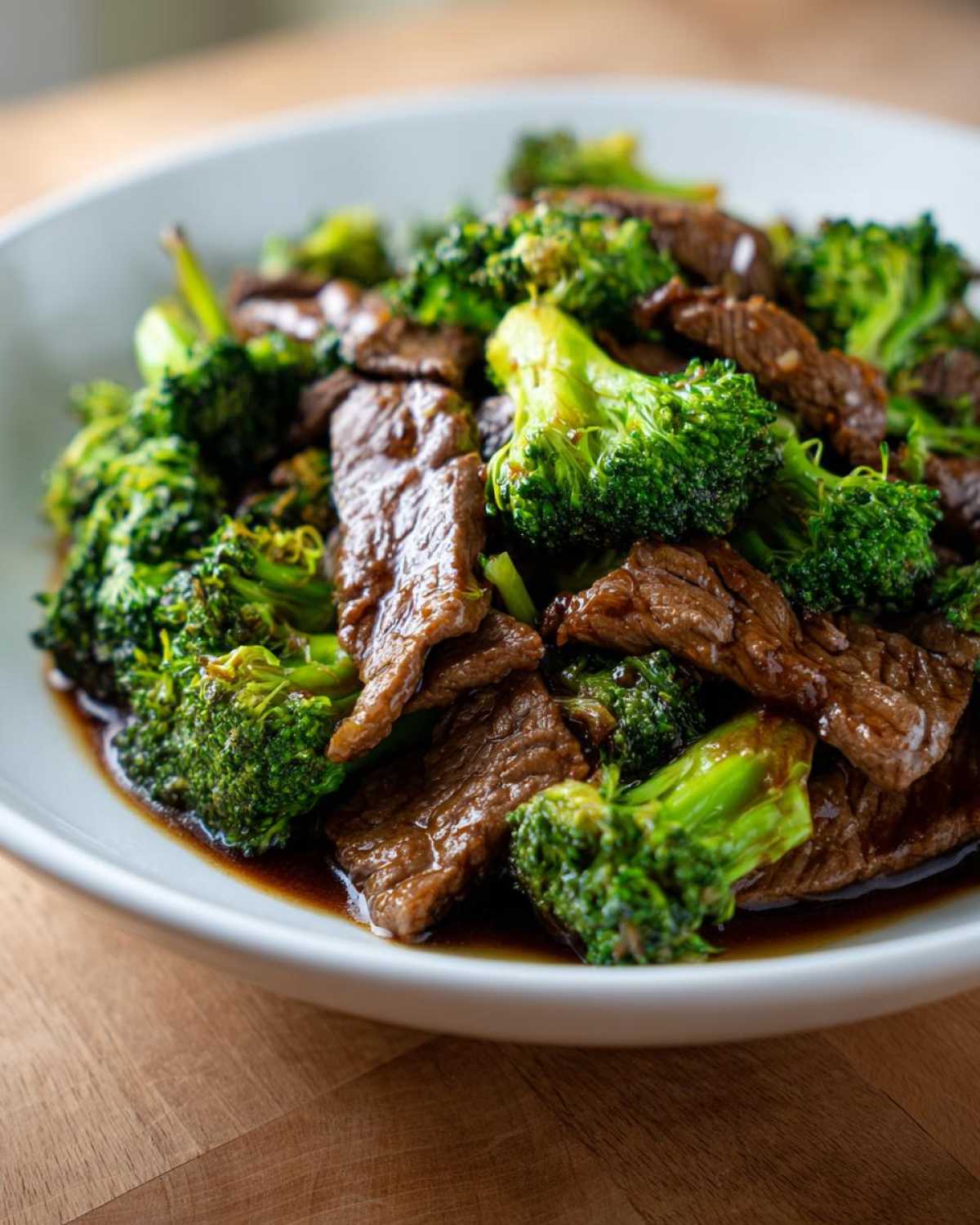 A close-up shot of tender slices of beef coated in sauce mixed with bright green broccoli florets, representing Instant Pot Beef and Broccoli.
