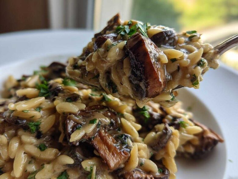 A spoonful of creamy One-Pot Creamy Mushroom Orzo, rich with brown mushrooms and parsley garnish.