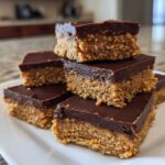 A stack of rich, two-layer 250 calorie Peanut Butter Bars with a thick chocolate topping.