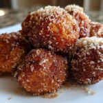 Close-up of golden brown Air Fryer Crispy Cinnamon Sugar Pretzel Bites heavily coated in sparkling sugar.