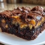 Close-up of a decadent slice of Chocolate Caramel Dump Cake showing gooey caramel and chocolate topping.