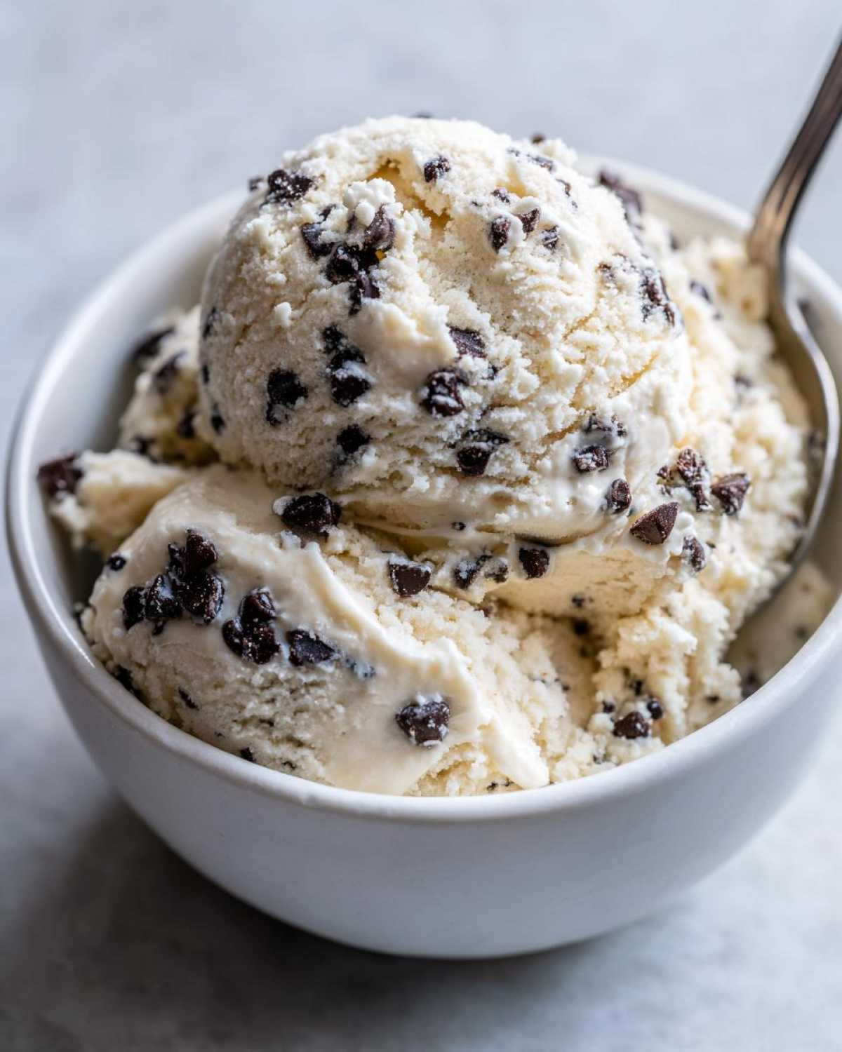 Scoops of creamy vanilla ice cream loaded with mini chocolate chips, resembling Greek Yogurt Cookie Dough.