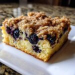Close-up of a square slice of Easy Sheet Pan Blueberry Streusel Pancake with a thick brown sugar streusel topping.