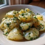 Close-up of tender Instant Pot Creamy Garlic Butter Potatoes tossed in butter sauce and fresh parsley.
