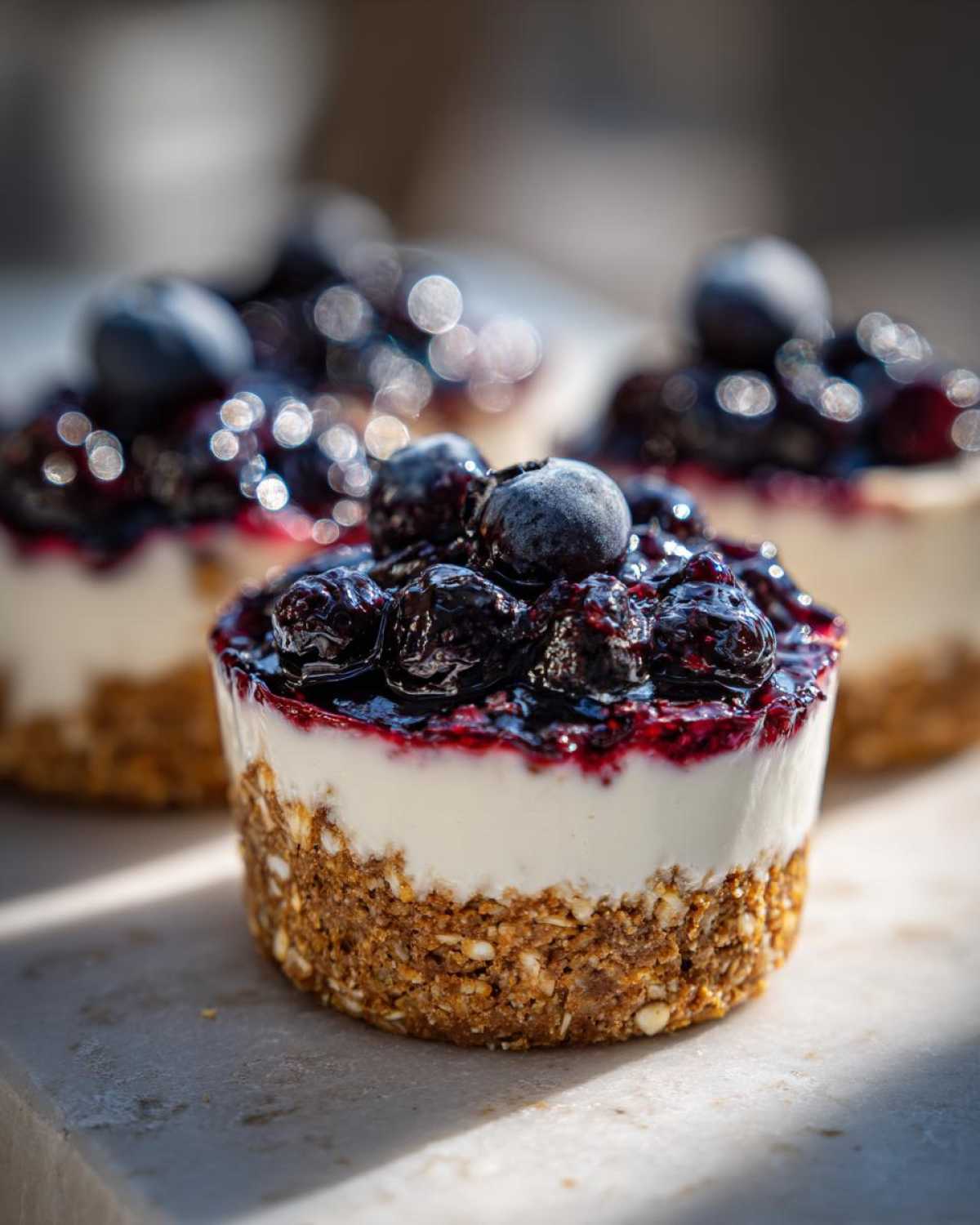 Close-up of a No-Bake Blueberry Cheesecake Oat Cup with a thick oat crust and blueberry topping.