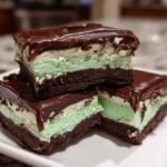 Three stacked squares of No-Bake Chocolate Mint Icebox Bars showing chocolate base, mint layer, and ganache topping.