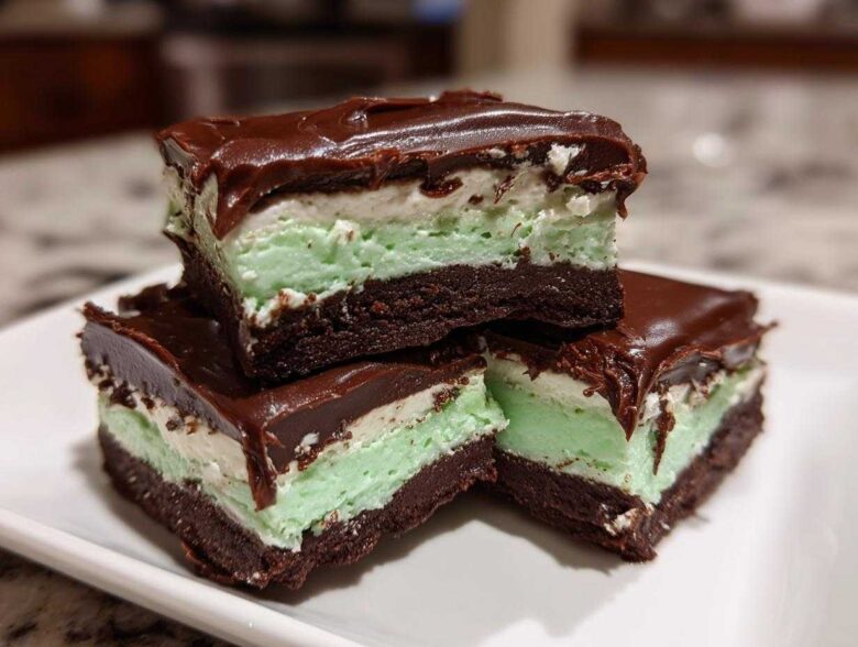 Three stacked squares of No-Bake Chocolate Mint Icebox Bars showing chocolate base, mint layer, and ganache topping.