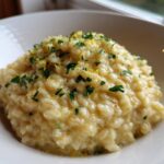 Close-up of creamy One-Pot Creamy Lemon Garlic Farro topped with fresh parsley and lemon zest.