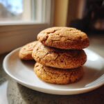 A stack of three chewy Brown Sugar Cookies, coated in sparkling sugar crystals, resting on a white plate.